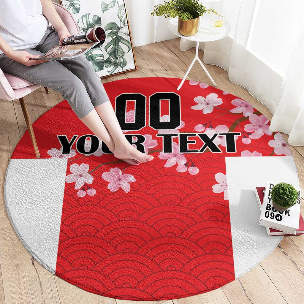 Red circular rug with wave pattern center, cherry blossoms, and bold custom text.