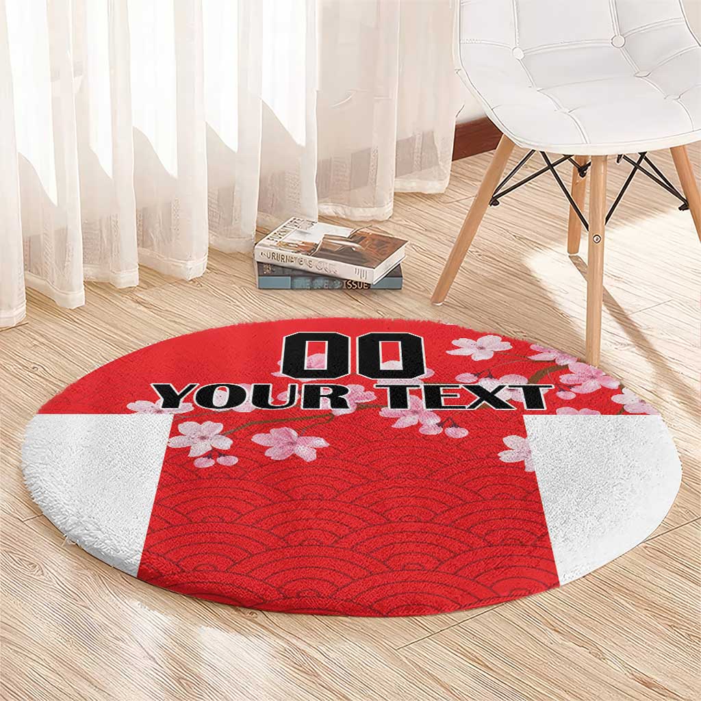 Red circular carpet with wave pattern, cherry blossoms, and custom text on light backing.
