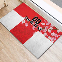 Red customizable doormat with white blocks, cherry blossoms, and wave pattern