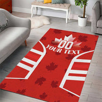 Red Canada flag area rug with maple leaf motifs and white custom text, open living space