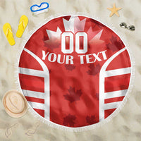 Red round beach blanket with white maple-leaf graphic, '00 YOUR TEXT' and fringed edge