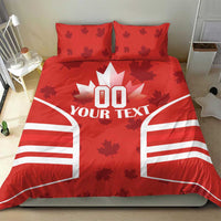 Red bedding set with maple leaf accents and 'YOUR TEXT' center design with striped sides