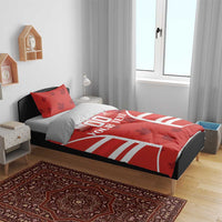 Red duvet and pillowcases with maple leaves, rugby-style stripes, and 'YOUR TEXT' design