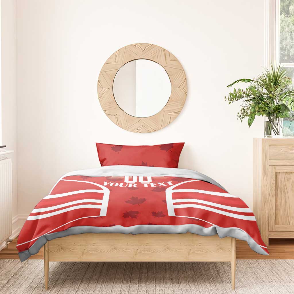 Red duvet with maple-leaf pattern and 'YOUR TEXT' over striped panels on bed