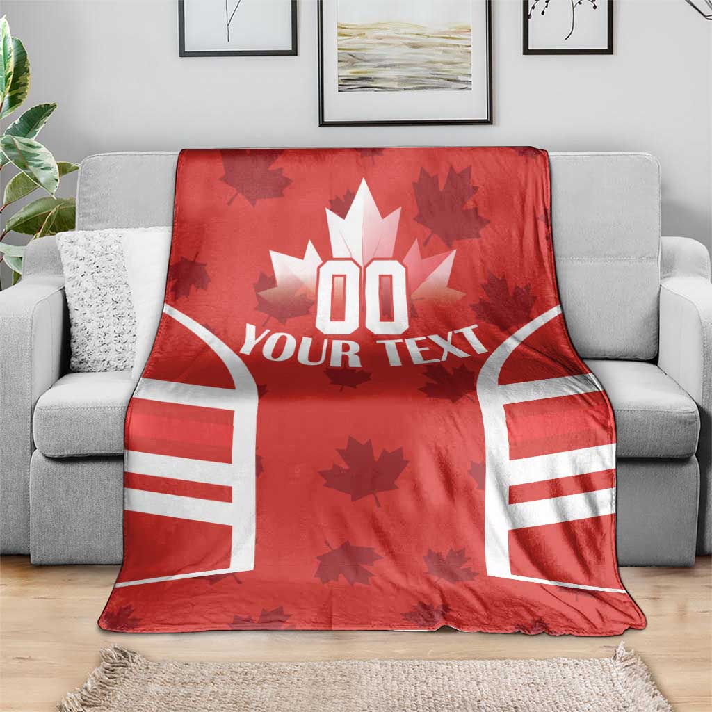 Red Canada flag-style rugby blanket draped over a gray sofa, white “YOUR TEXT” graphic