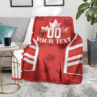 Red Canada flag-style rugby blanket shown over a gray chair with “YOUR TEXT” print