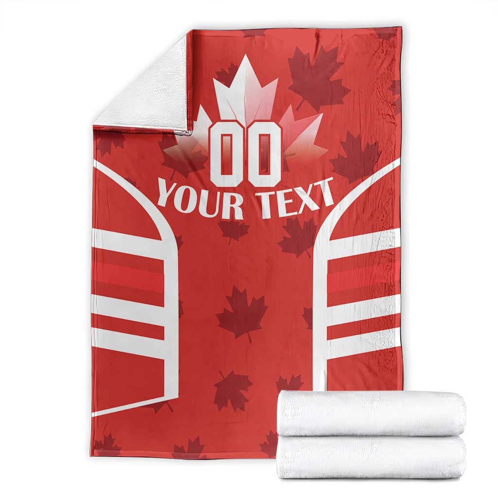 Red Canada flag-style rugby blanket folded and stacked with “YOUR TEXT” and maple leaf