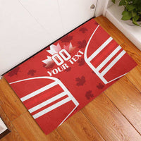 Red rubber doormat with Canadian flag arch design, maple leaves, and 'YOUR TEXT'.
