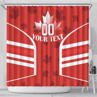 Red shower curtain with white maple leaf centerpiece, bold striped wings, and top hanging tabs