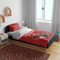 Red and white duvet bedding set on a bed; custom text and goose rider graphic
