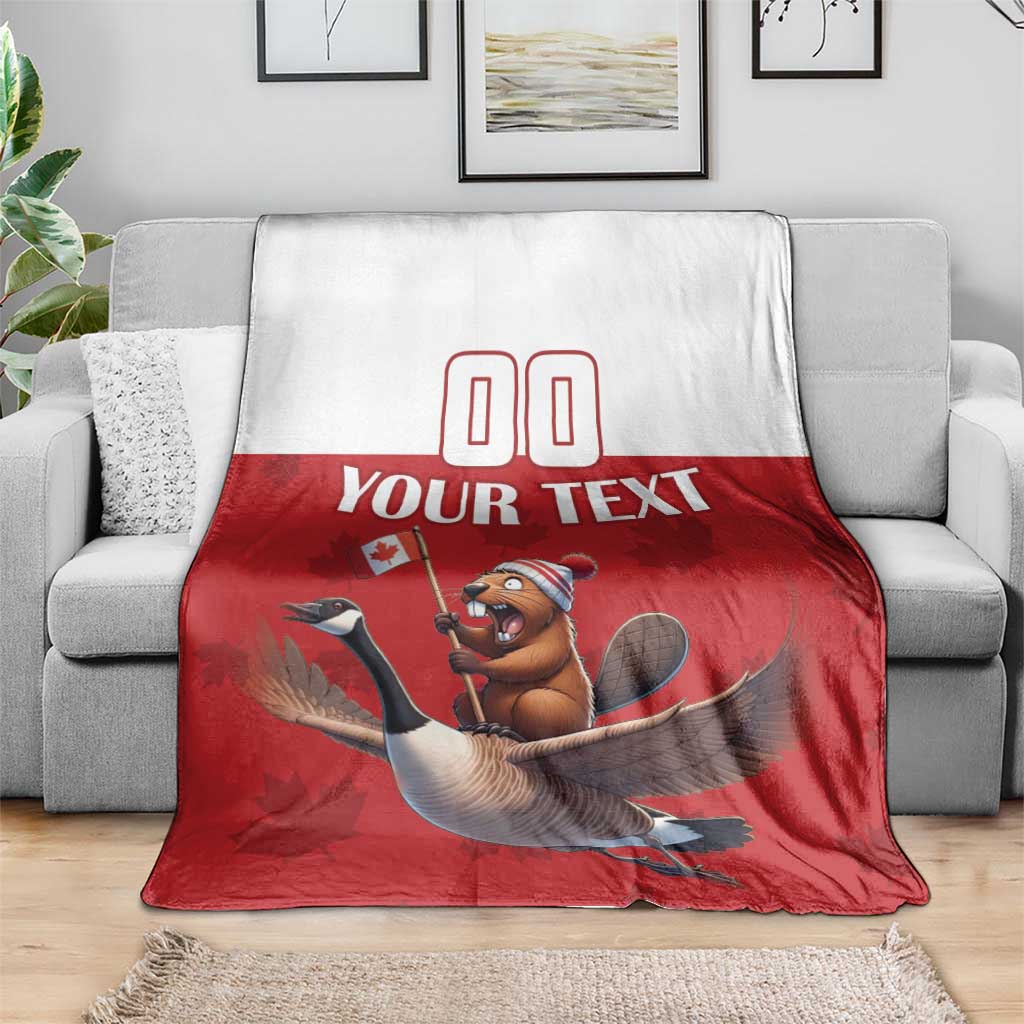 Custom rugby blanket on gray sofa, red lower half with beaver riding goose graphic