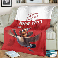 Red and white custom rugby blanket on couch, beaver riding goose and 'YOUR TEXT' text