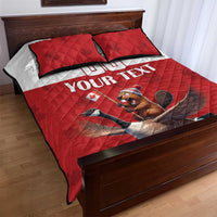 Red quilted bed set with two pillows and Canada-themed beaver-and-goose graphic with text