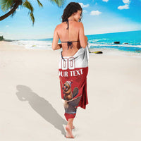 Red sarong shown from the back with beaver riding goose artwork and “YOUR TEXT”
