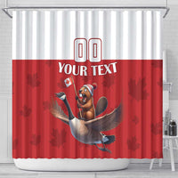 Red and white shower curtain with beaver riding goose, maple leaves and 'YOUR TEXT', hanging.
