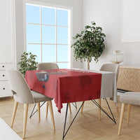 Red tablecloth on dining table featuring a goose centerpiece graphic