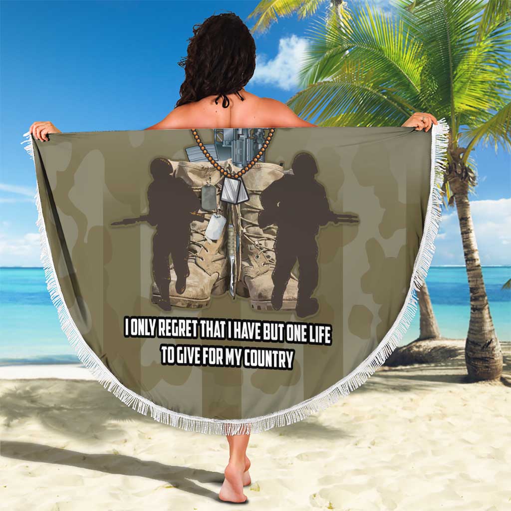 Round navy beach blanket with white fringe, soldier graphic and 'I ONLY REGRET...' text