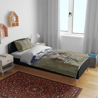 Personalized bedding set on bed: olive camo duvet with blue star design and “YOUR TEXT”