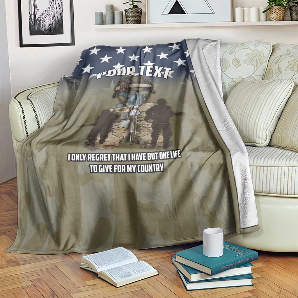 Folded-on-bed camo blanket with navy stars, “YOUR TEXT” header, and patriotic quote
