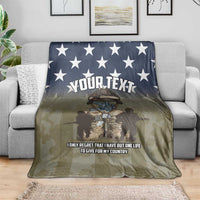 Camo throw blanket draped on couch with navy stars and “YOUR TEXT” personalization