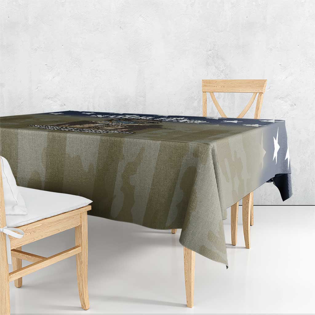 Veterans Day tablecloth in olive camo with navy star detail, draped on dining table