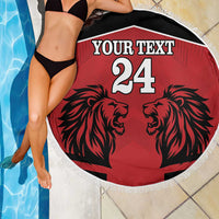 Round red beach blanket with black lion heads, white fringe edge, "YOUR TEXT 24"