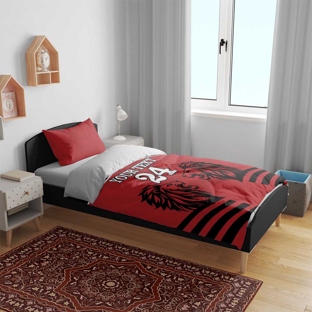 Red and black duvet bedding set with red pillowcases, lion heads graphic and bold stripe bands