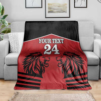 Red & black rugby blanket with lion heads, 'Your Text' and number 24 on couch