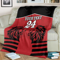Red & black rugby blanket with lion heads, 'Your Text' and number 24 on bed