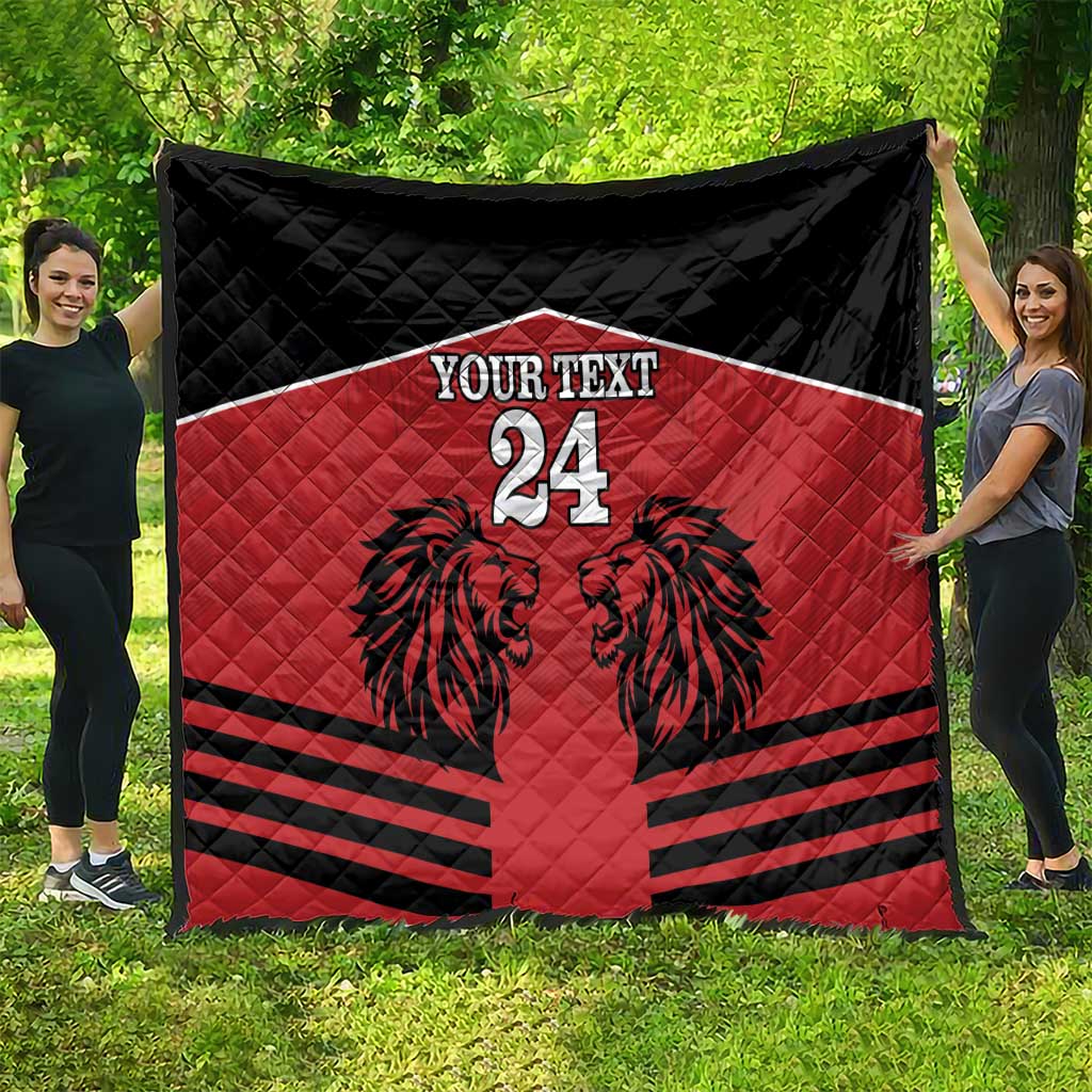 Red and black quilt blanket with lion design, 'YOUR TEXT' and number 24, spread out.