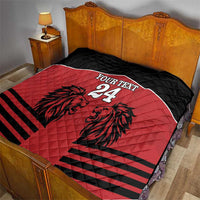 Red and black quilt blanket with lion design, 'YOUR TEXT' and number 24 on a bed.