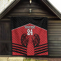 Red and black quilt blanket with lion design, 'YOUR TEXT' and number 24 hanging outside.