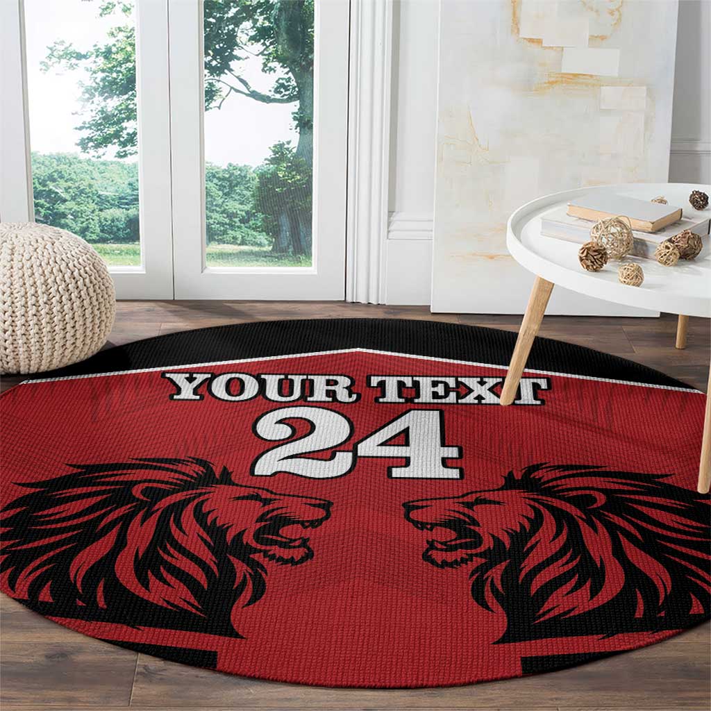 Red round rug with black lion faces and 'YOUR TEXT 24' centered over dark edge