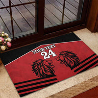 Red rubber doormat with black border, lion heads, and 'YOUR TEXT 24' across stripes.