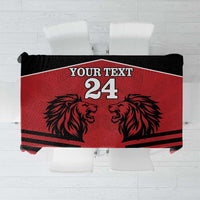 Red tablecloth with black lion head graphic and rugby-style stripes