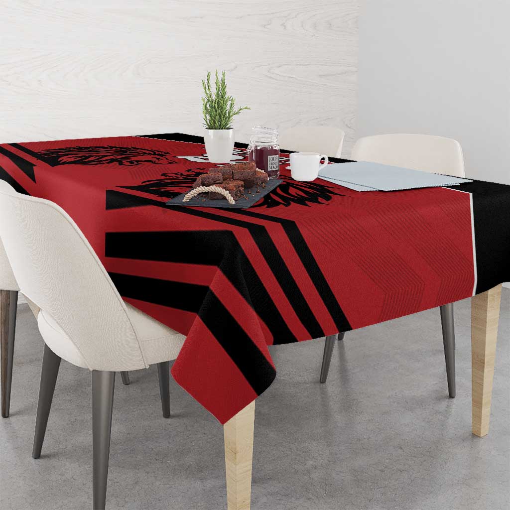 Red tablecloth with black diagonal stripe rugby pattern and lion artwork