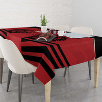 Red tablecloth with black diagonal stripe rugby pattern and lion artwork