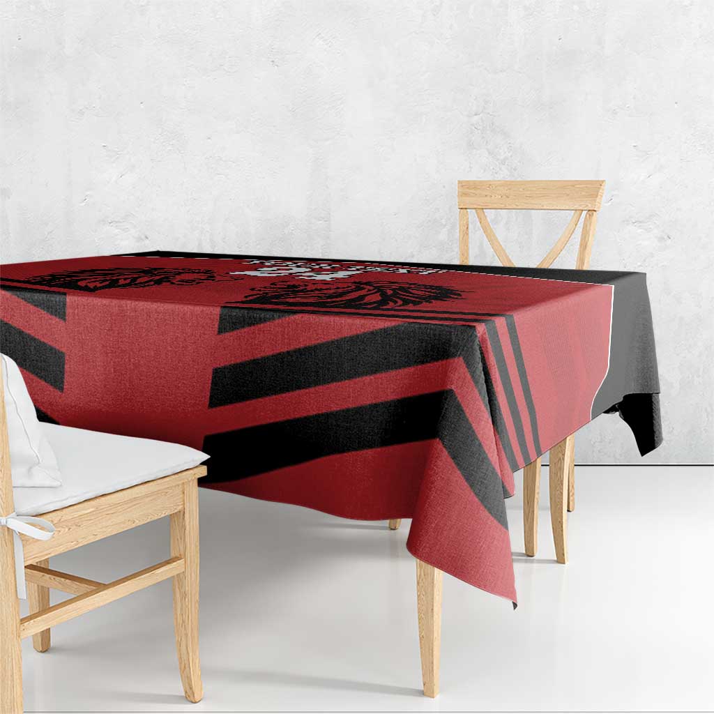 Red and black diagonal rugby stripe tablecloth draped on bench