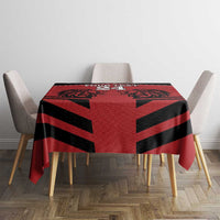 Red tablecloth with black geometric stripe pattern on dining table