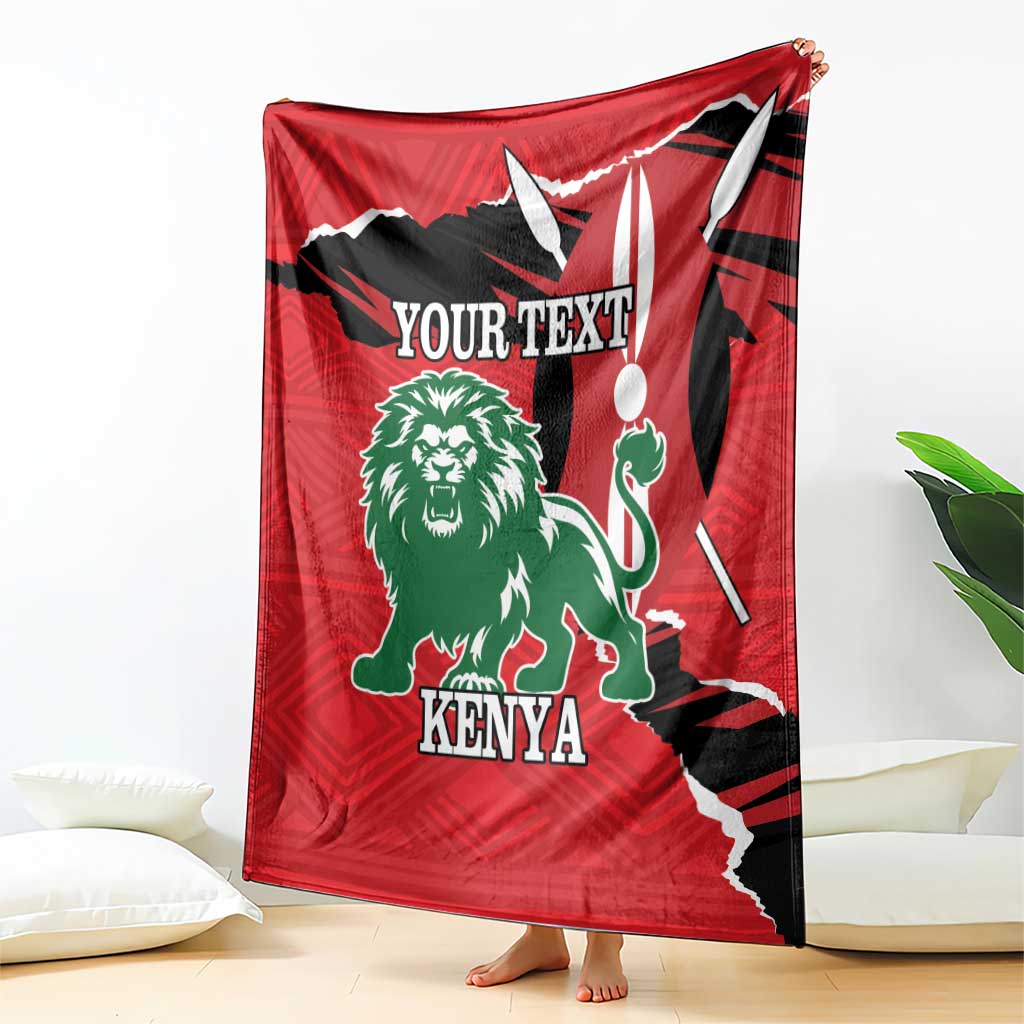 Red fleece blanket with lion and Kenya print, draped over chair with corner fold