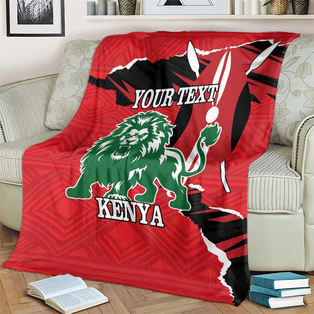 Red decorative blanket with green lion artwork, Kenya text, and bold black accents