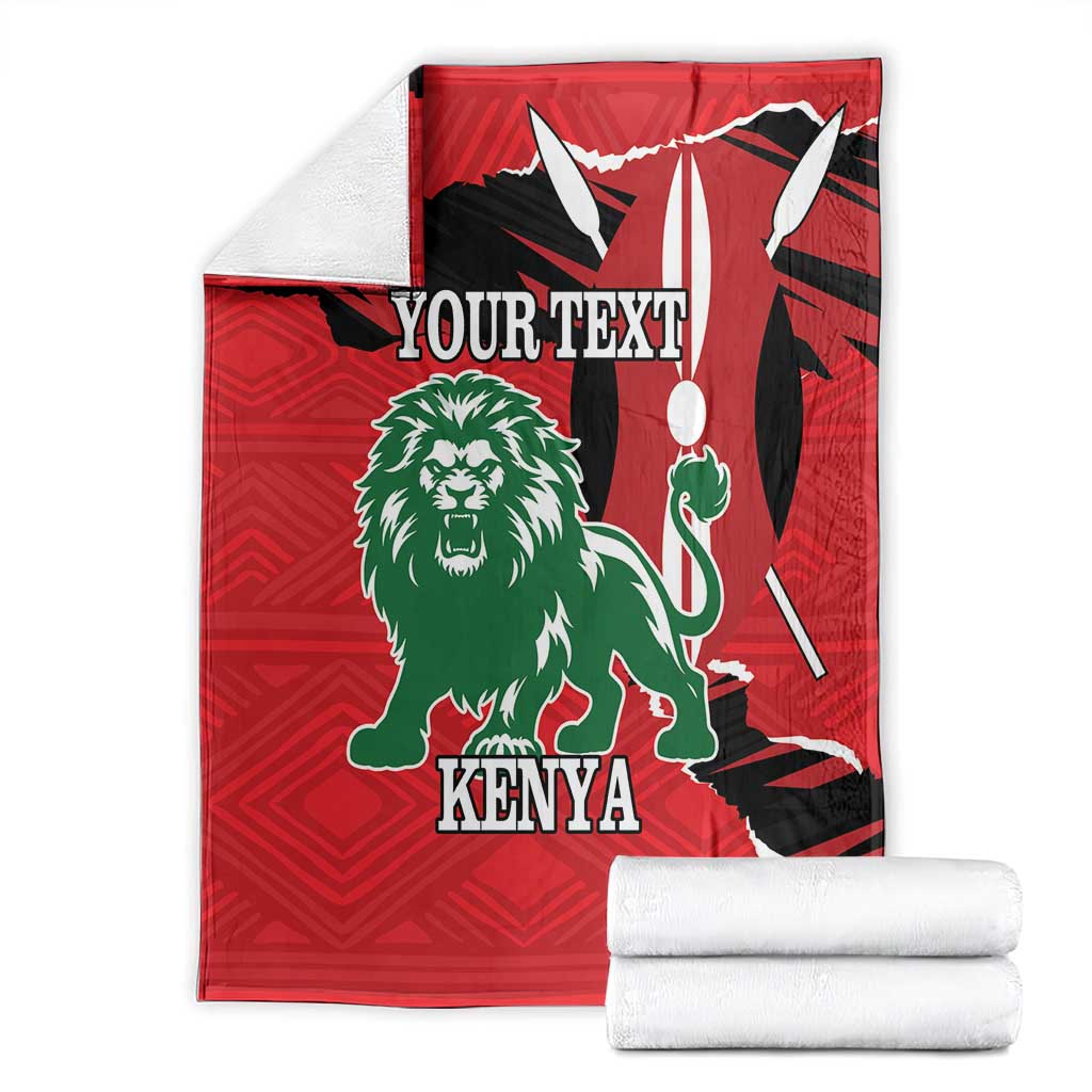 Red blanket set with green lion, Kenya text, and white rolled fabric beside it