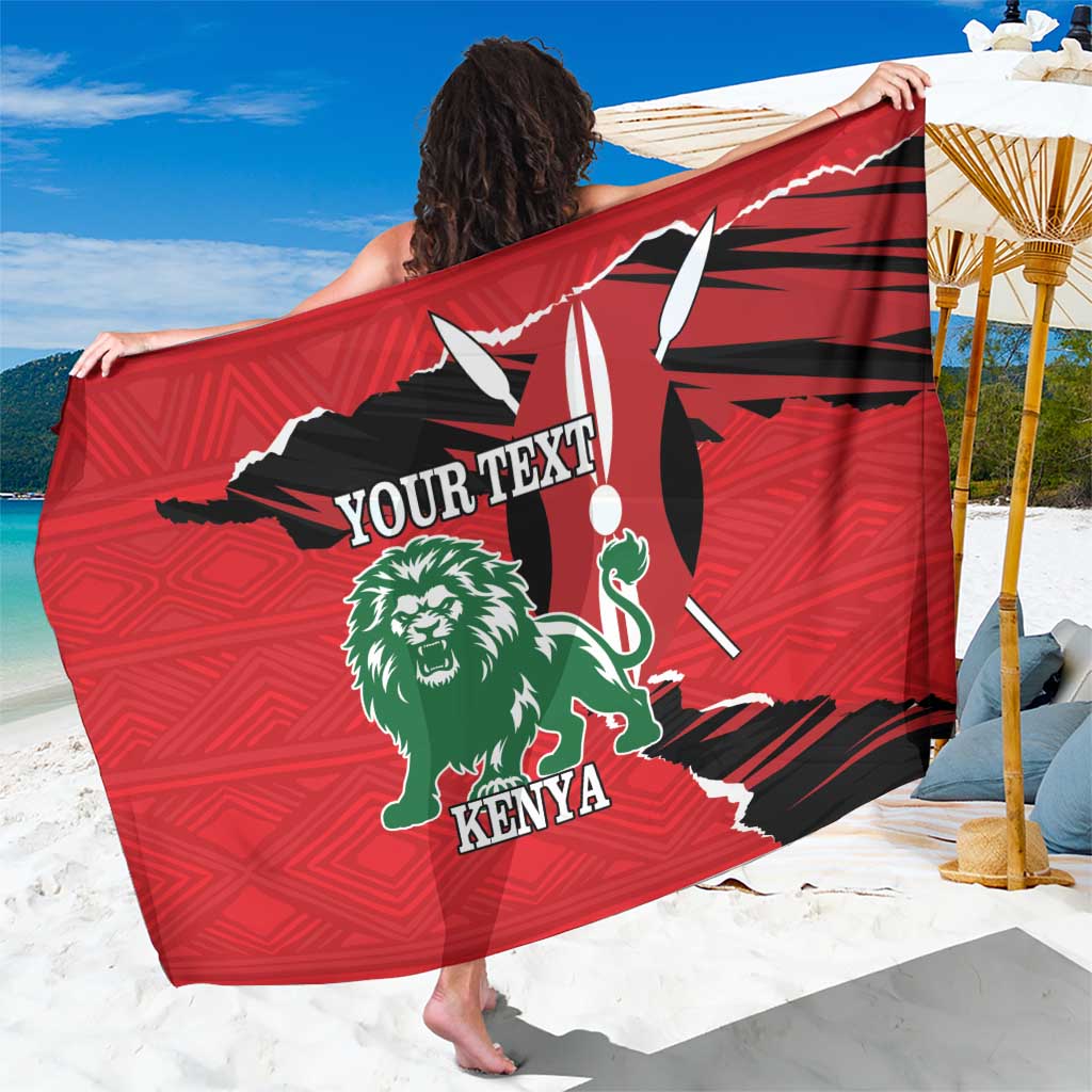 Red personalized sarong with green lion graphic and Kenya text, worn by person