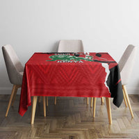 Red Kenya themed tablecloth with lion crest design on dining table