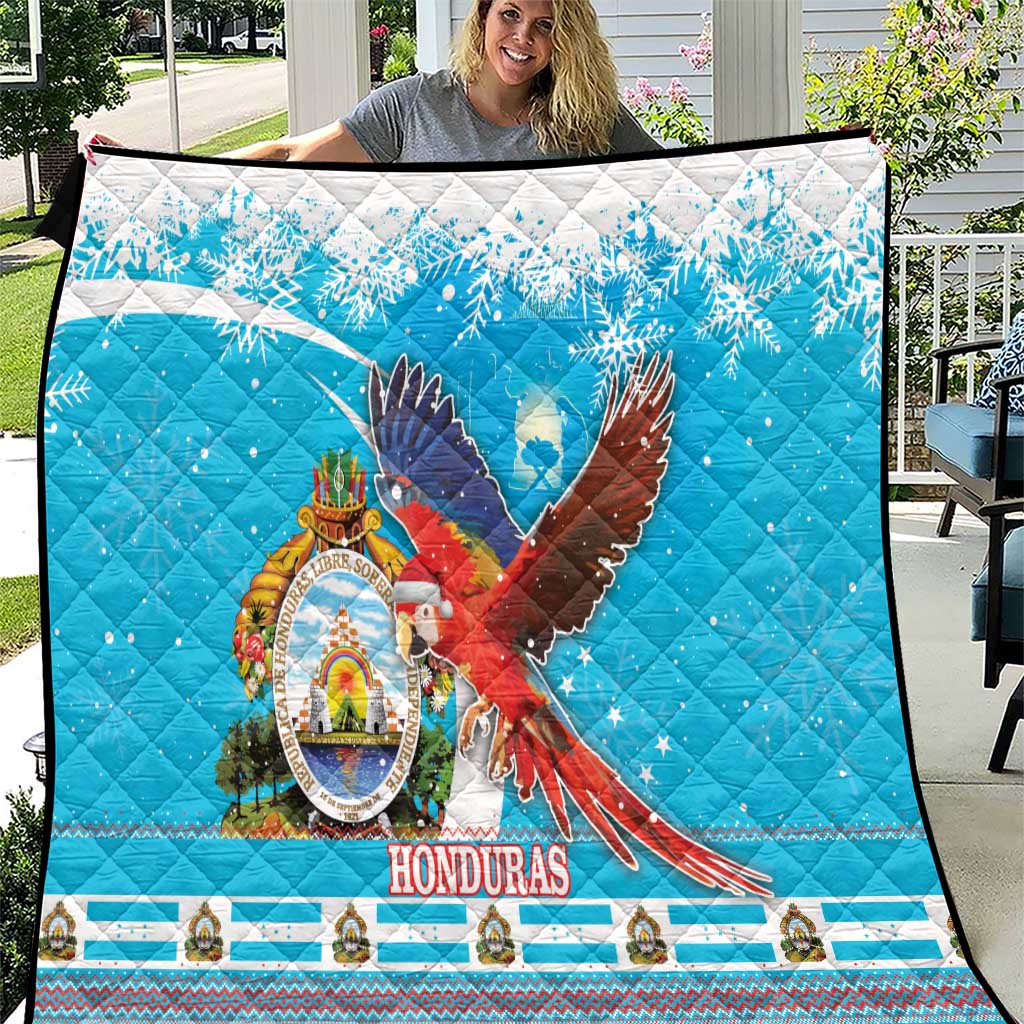Blue quilt blanket with colorful macaw and Honduras crest, snowflake pattern and border