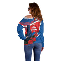 Women’s blue off-shoulder sweater with back print showing Slovak flag, castle and roses