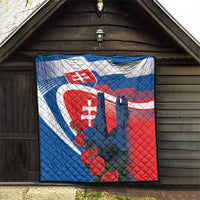 Quilted Slovakia blanket hanging on wooden barn wall with castle silhouettes and roses