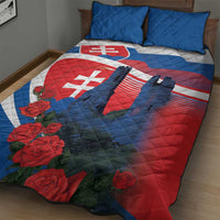 Red, white, and blue quilt with Slovak flag, roses, and castle silhouette; two blue pillows