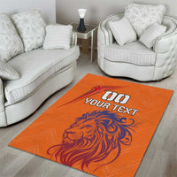 Orange area rug with lion illustration and 'YOUR TEXT' logo in the center