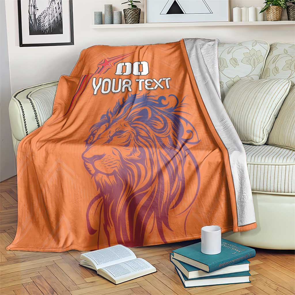 Orange throw blanket with lion and star graphic plus “YOUR TEXT” print